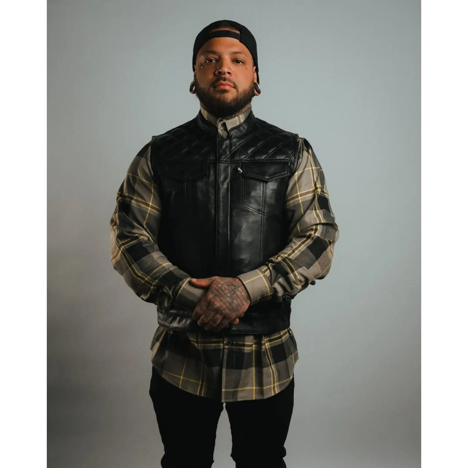 Man in Back In Black Leather Vest with YKK zippers and cowhide leather carry pockets