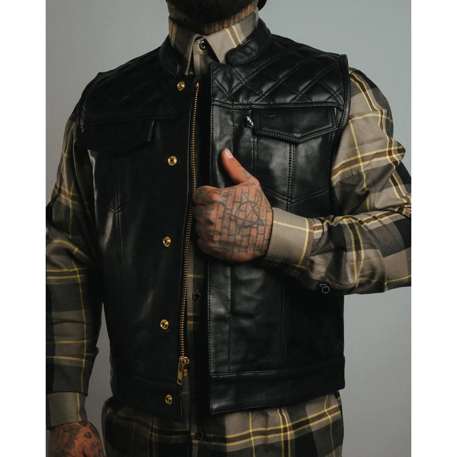 Black cowhide leather vest with gold YKK zippers and carry pockets, stylish double diamond vest