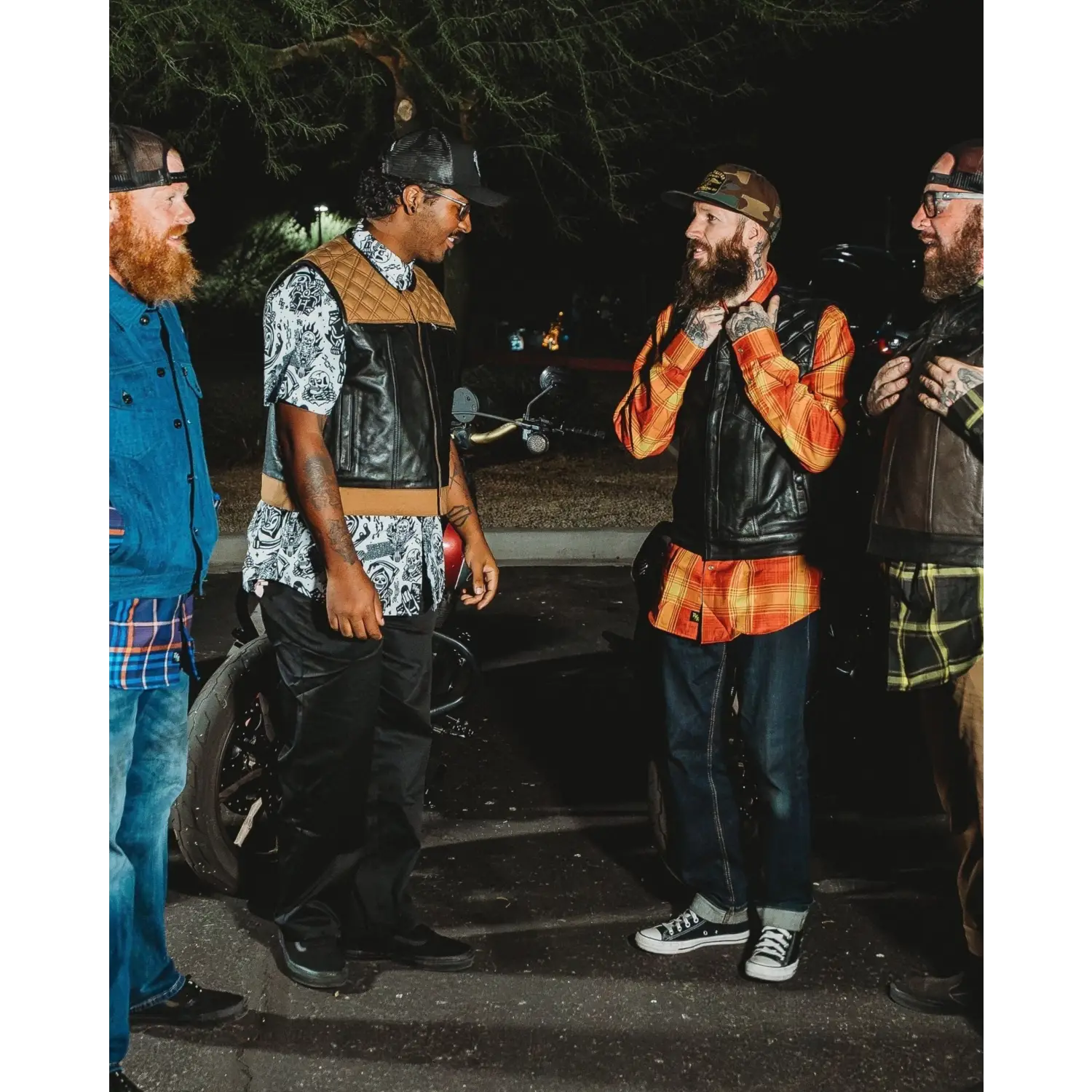 Group of men wearing black leather vests with concealed carry pockets and double diamond stitching