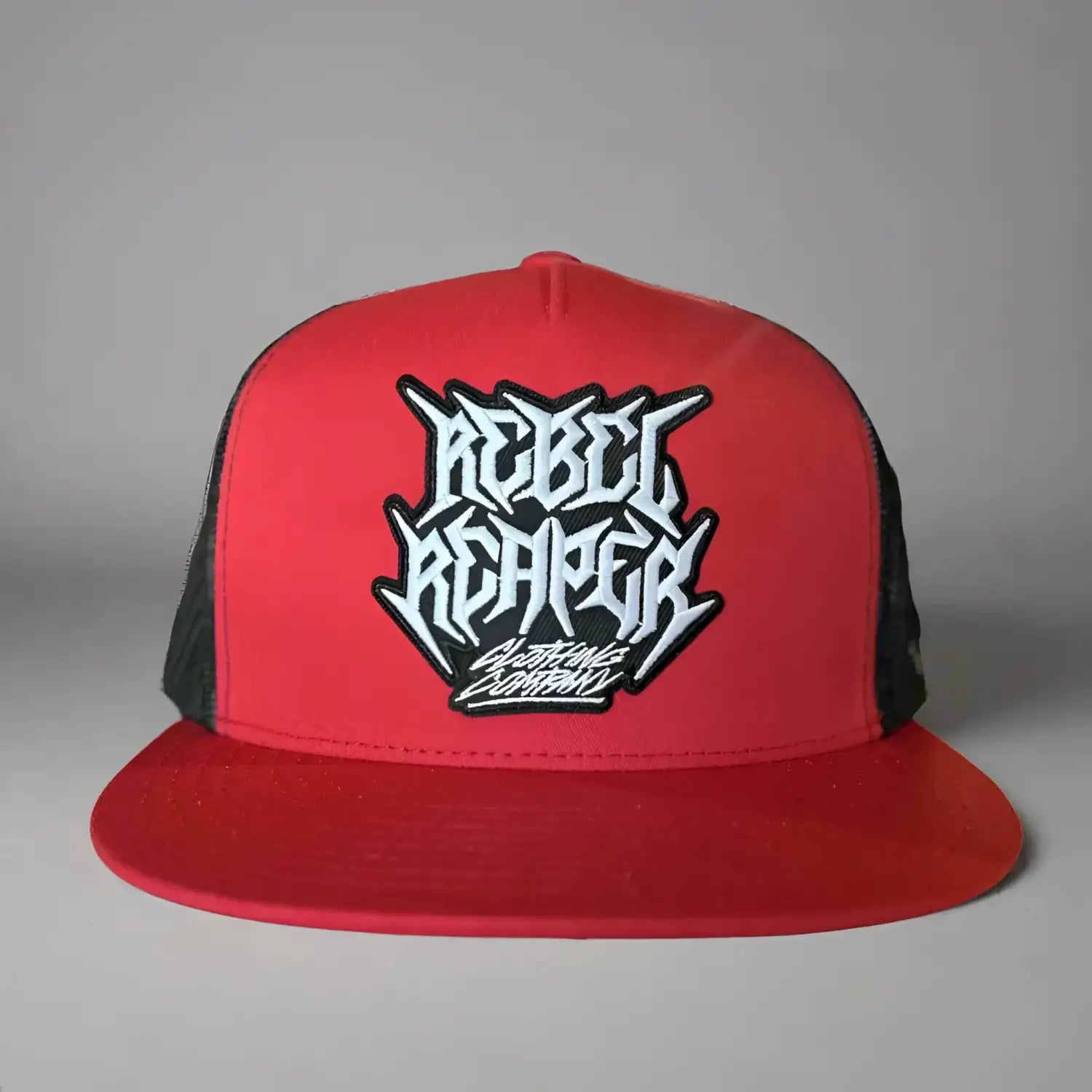 Red and black classic trucker hat with premium mesh panels for maximum ventilation