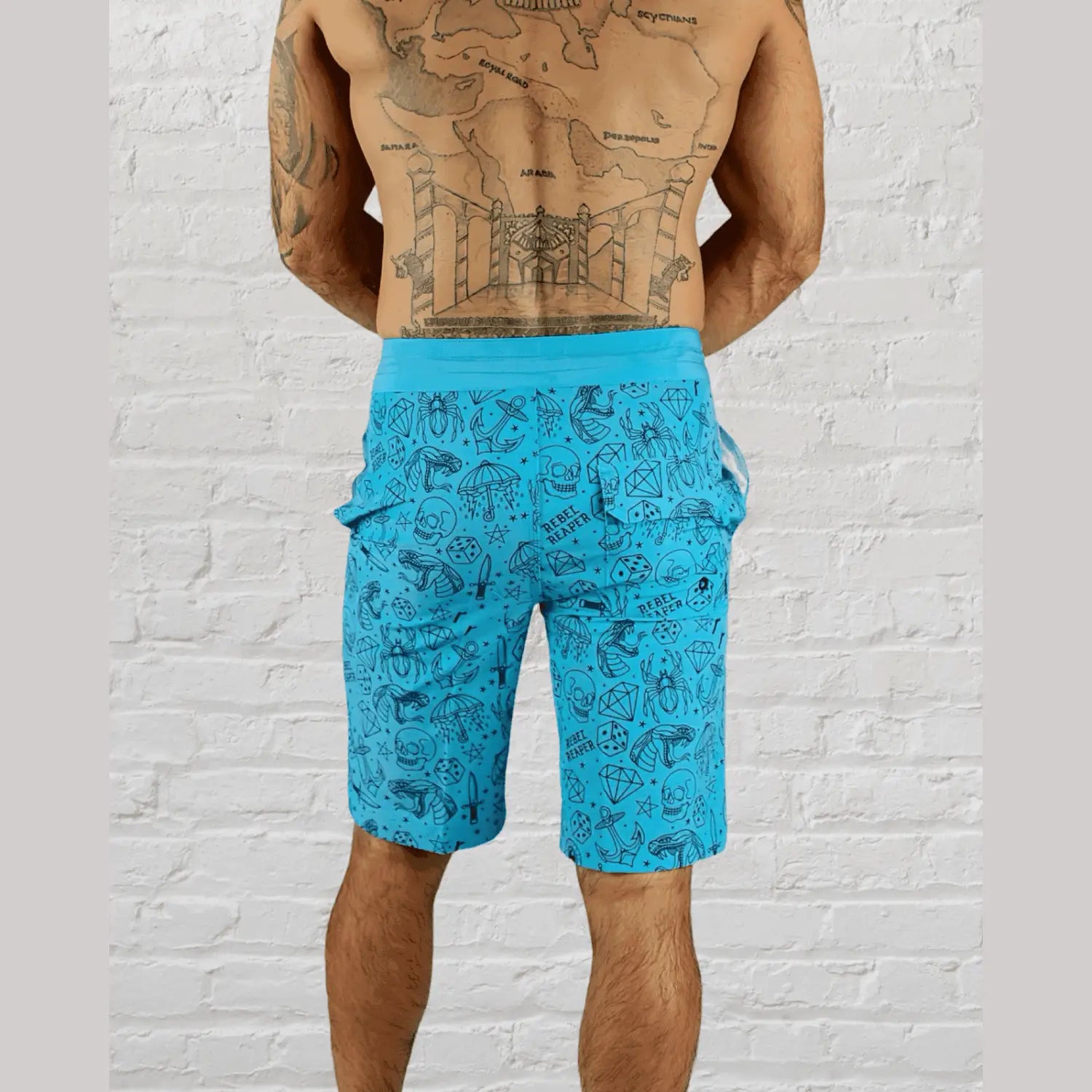 Blue patterned tattoo flash boardshorts made from eco-conscious fabric with velcro pockets