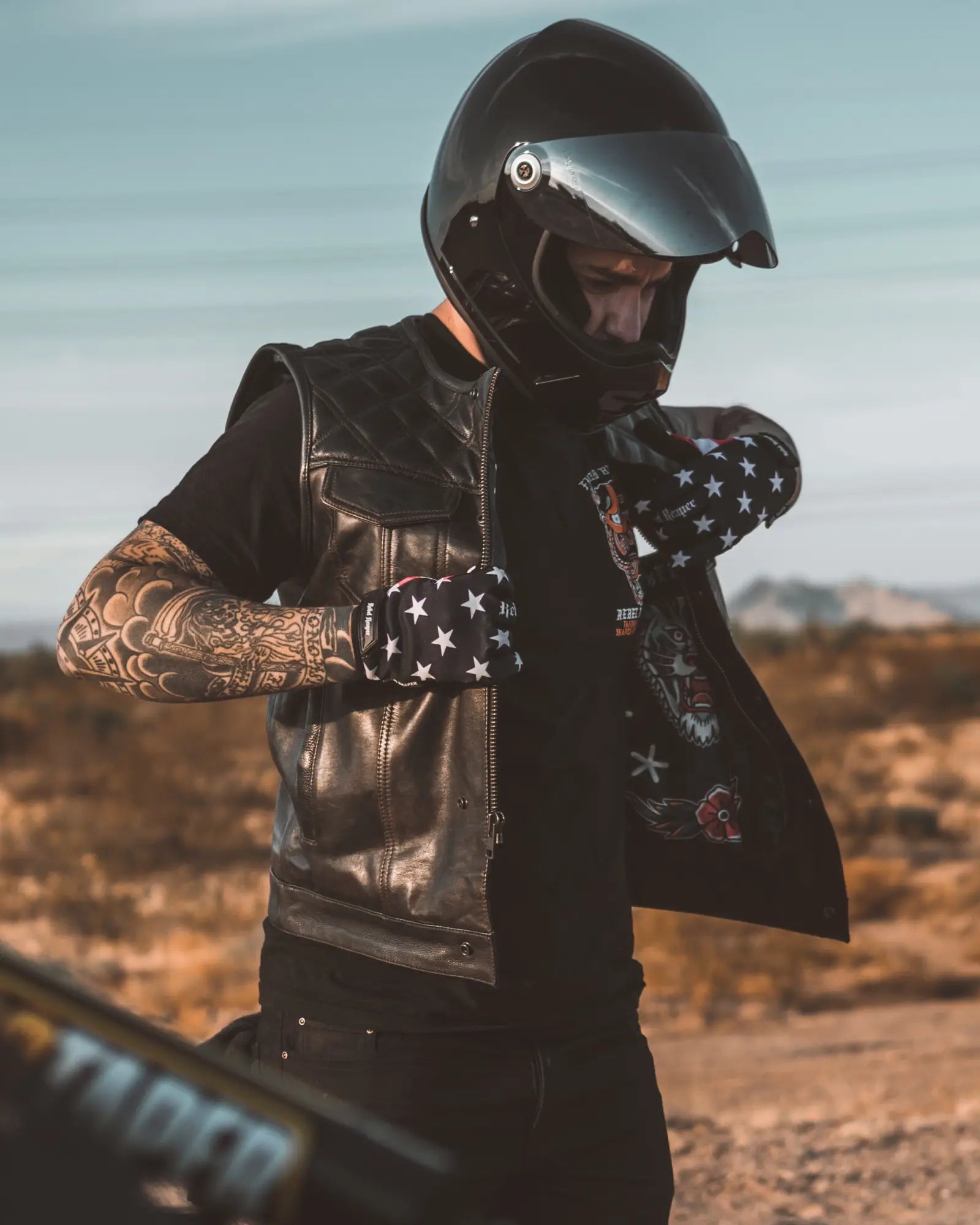 Motorcyclist in helmet and leather vest from All Products in-stock collection