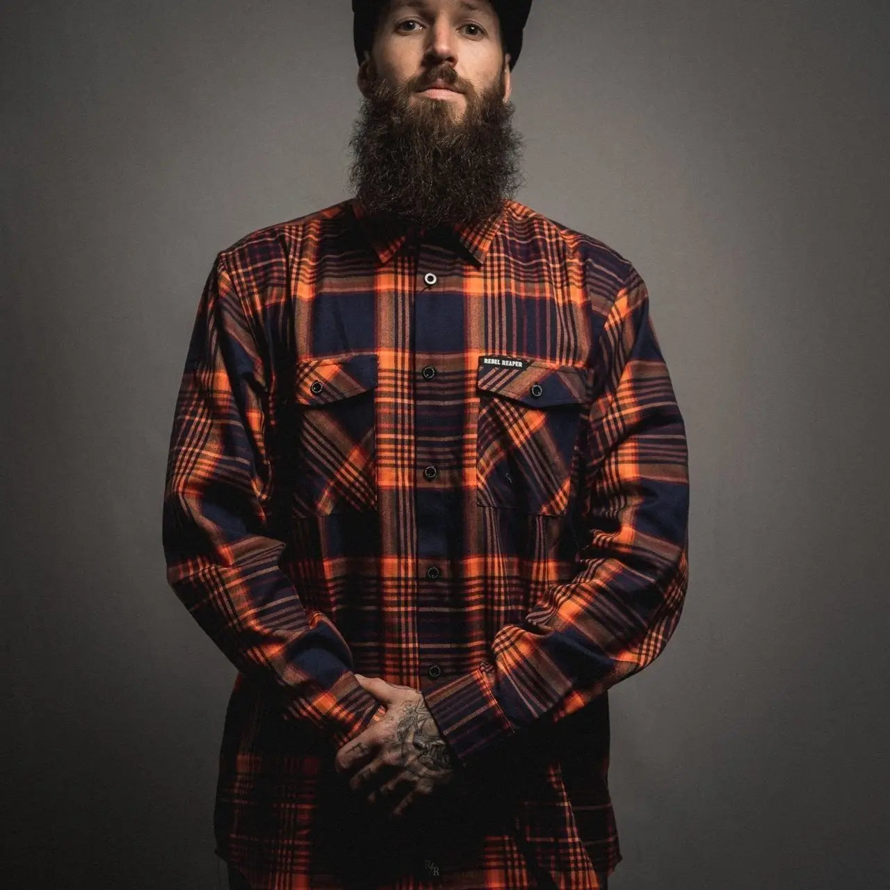 Orange and navy plaid shirt from Rebel Reaper Flannel collection, perfect for men’s flannel fashion