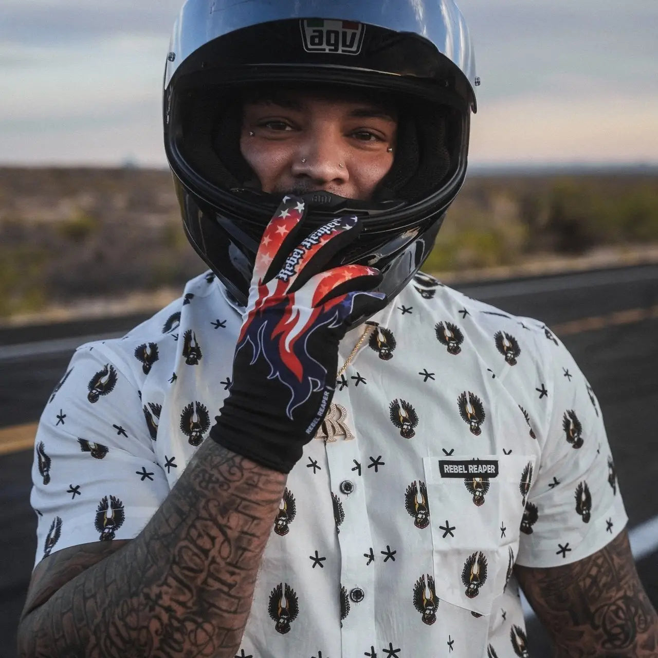 Motorcycle rider wearing helmet and patterned shirt with Moto Gloves MX gloves for riding