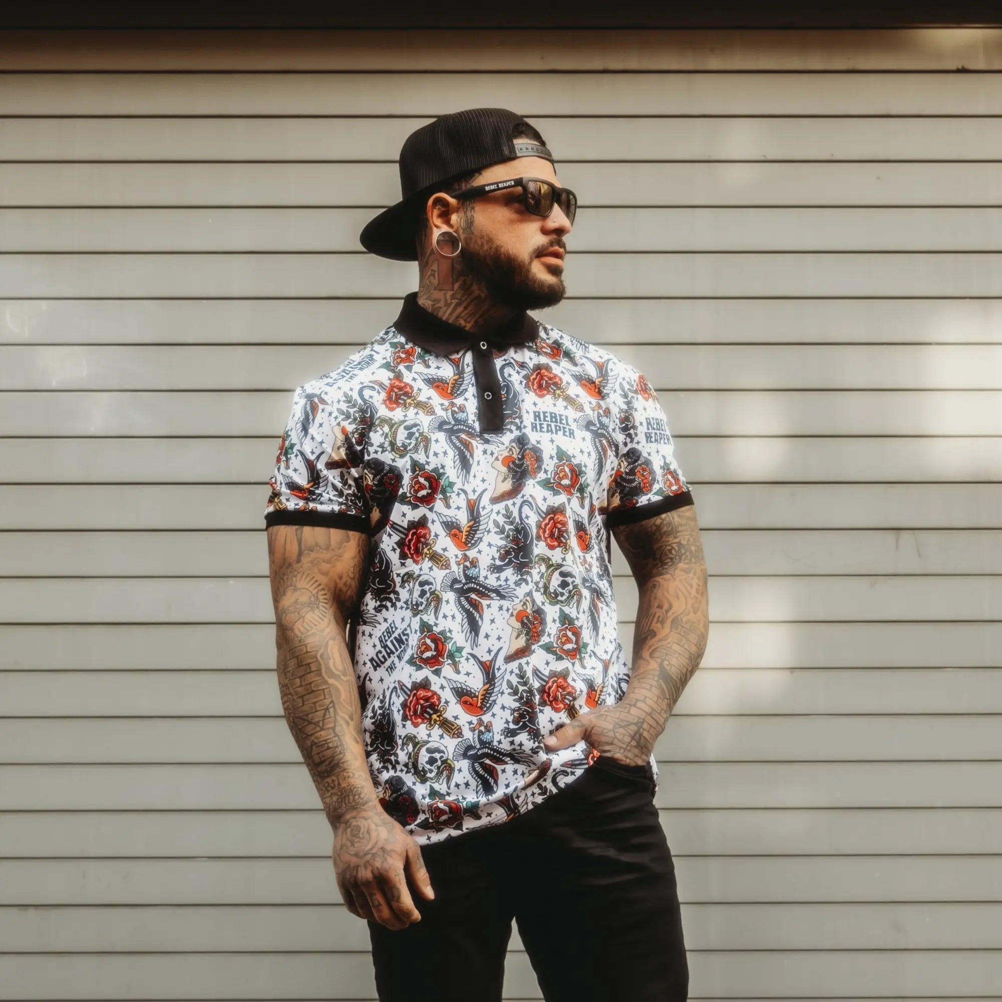 Man wearing patterned rebel reaper polo shirt in men’s polo shirts collection