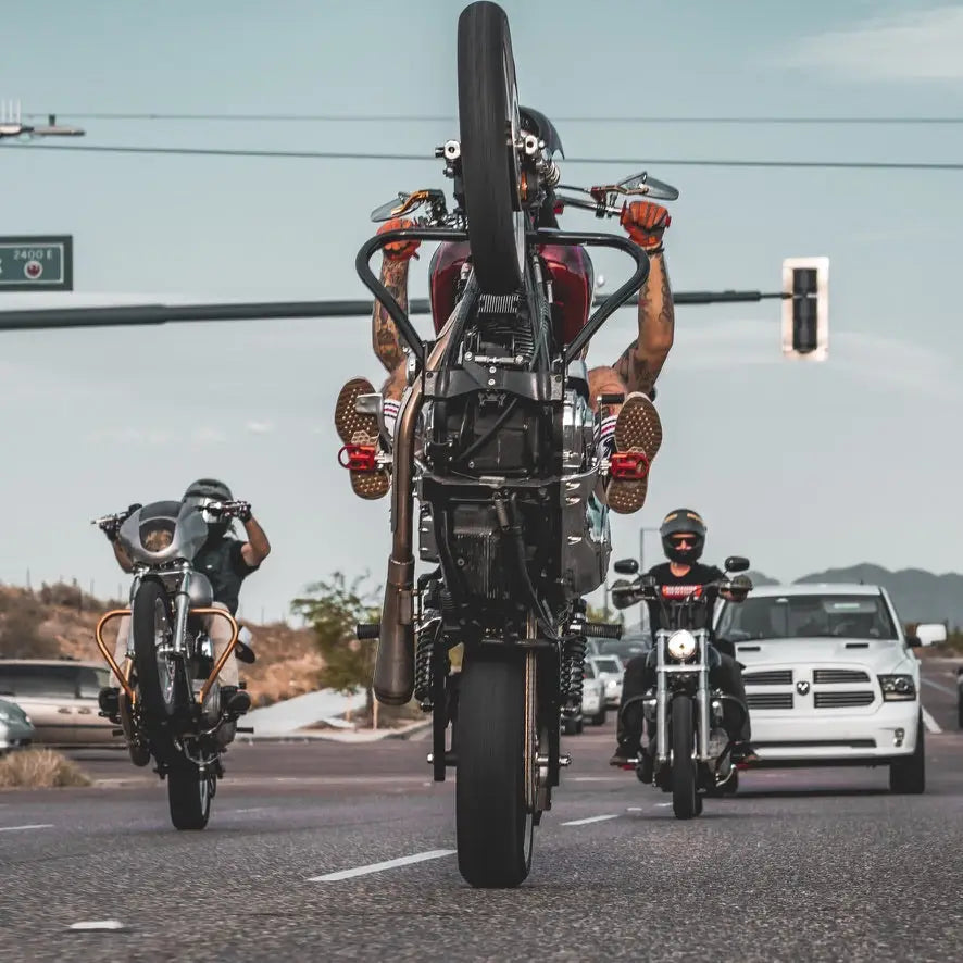 Motorcycles performing wheelies in Summer Collection featuring Rebel Reaper Clothing from Reaper Clothing Company