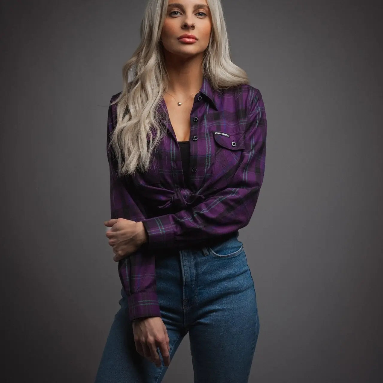 Woman in purple plaid flannel shirt and jeans from Womens Flannels collection