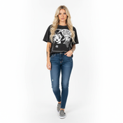 Woman wearing a black graphic t-shirt and blue jeans on a white background