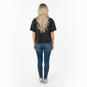 Person wearing a black t-shirt and blue jeans on a white background