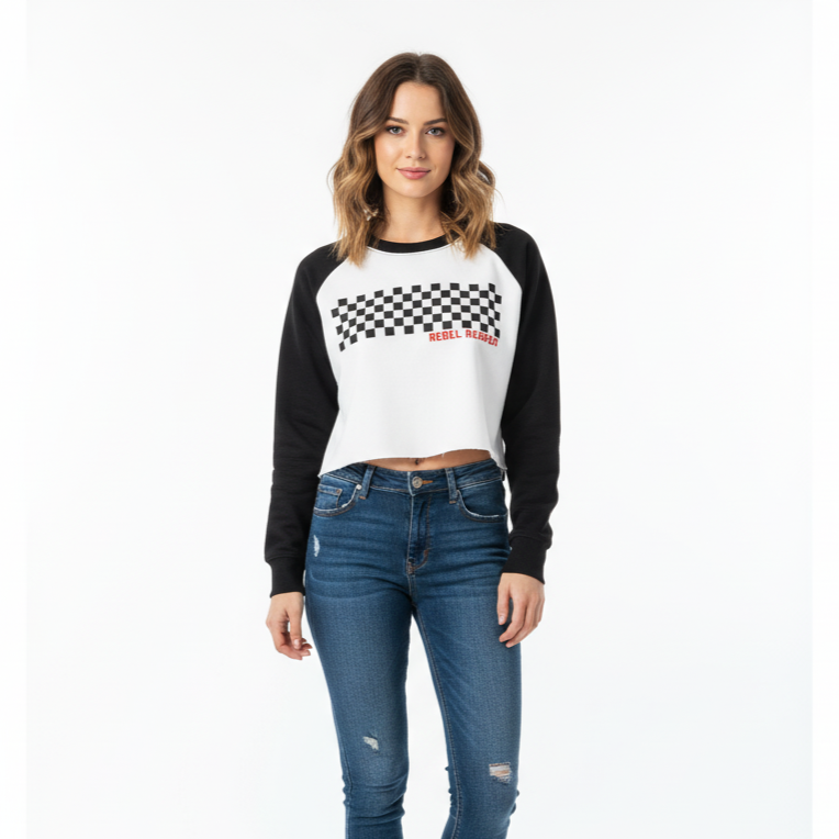 Woman wearing a black and white checkered shirt with a logo and blue jeans on a white background