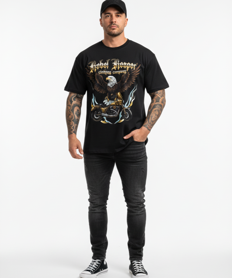 Man wearing a black t-shirt with an eagle graphic and text, standing against a white background