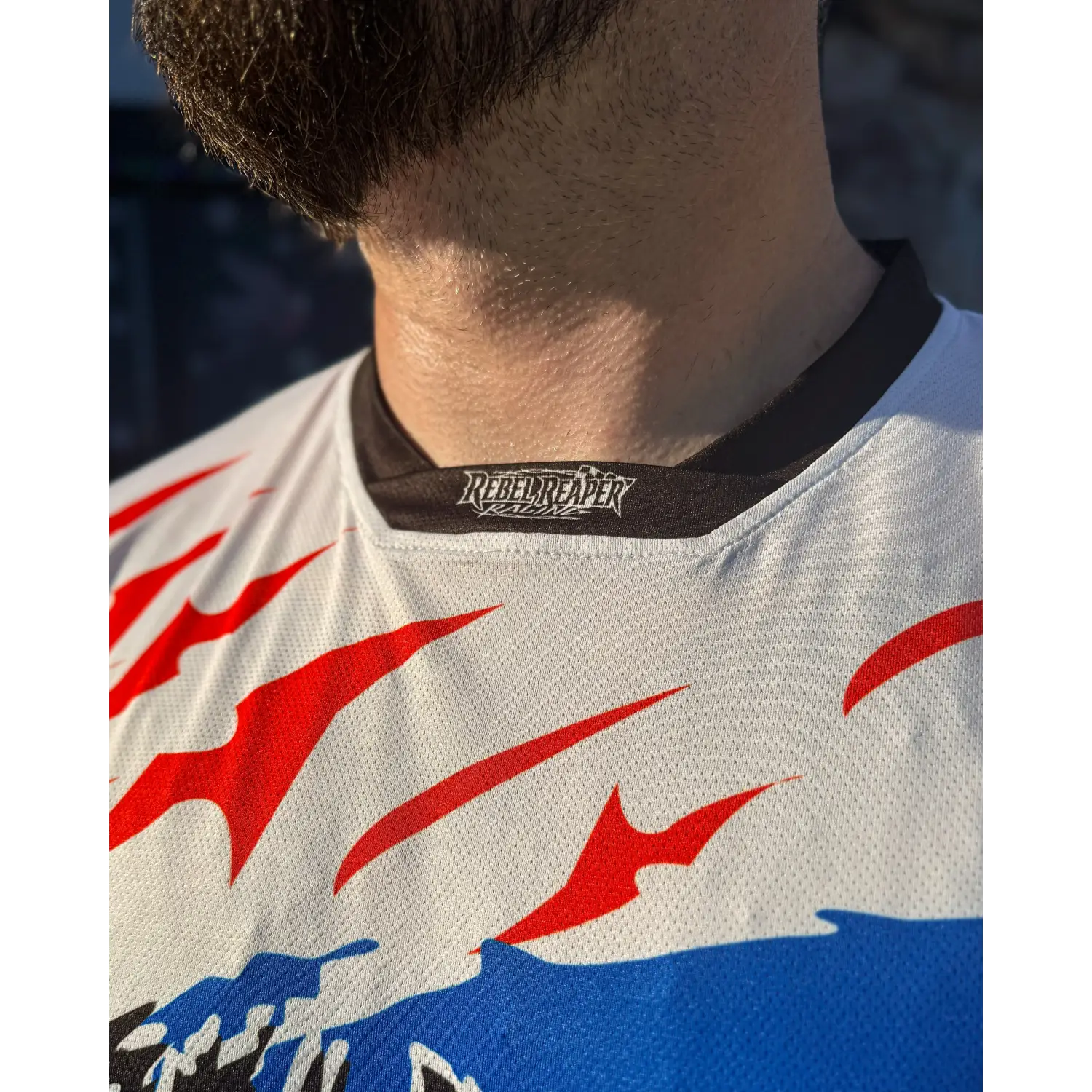 White rebel reaper racing jersey with red and blue accents for fly high and blow past speeds