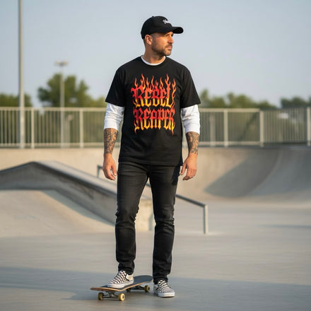 Man wearing a black t-shirt with 'Rebel Reaper' design at a skate park.