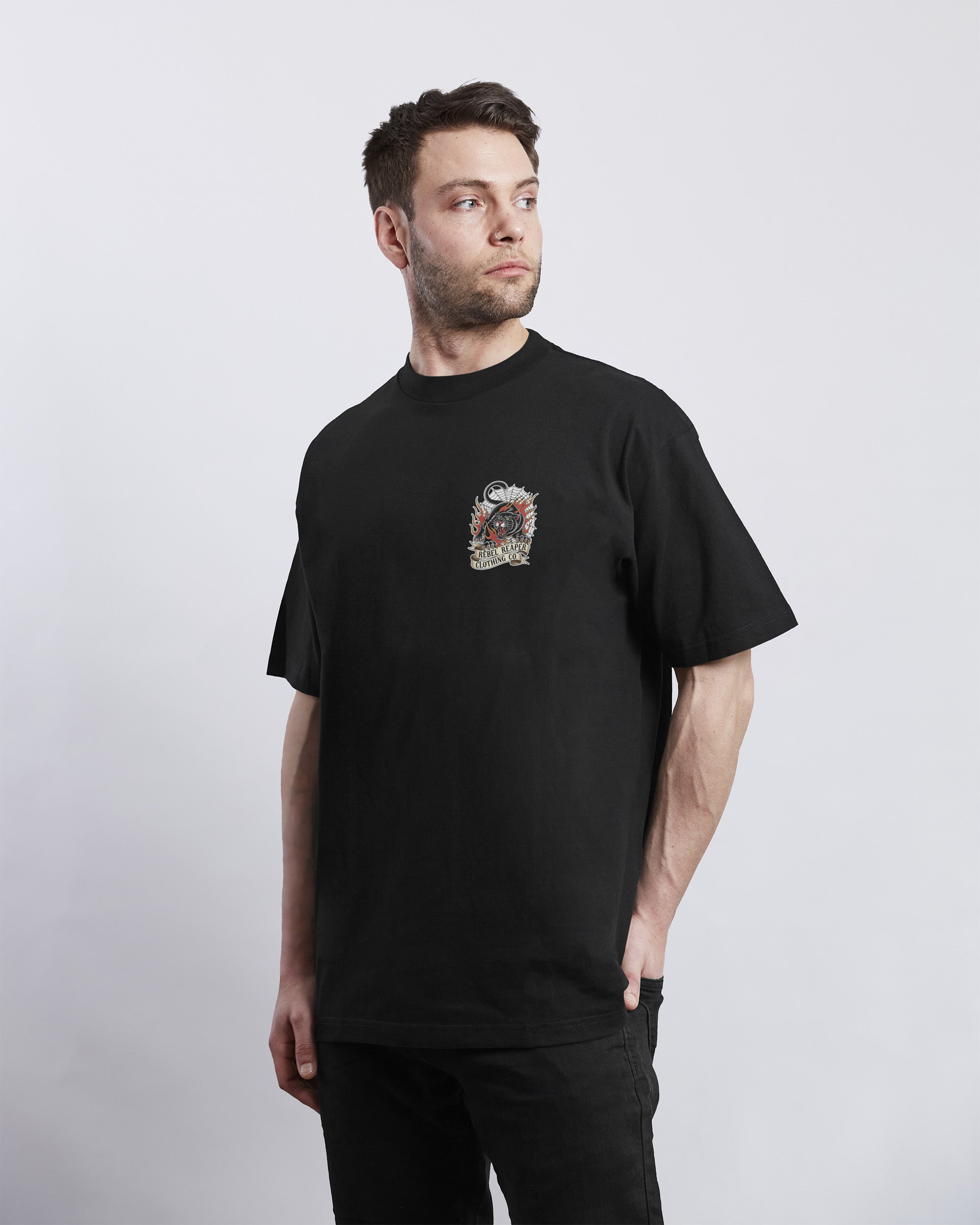 Man wearing a black t-shirt with a graphic design on a white background