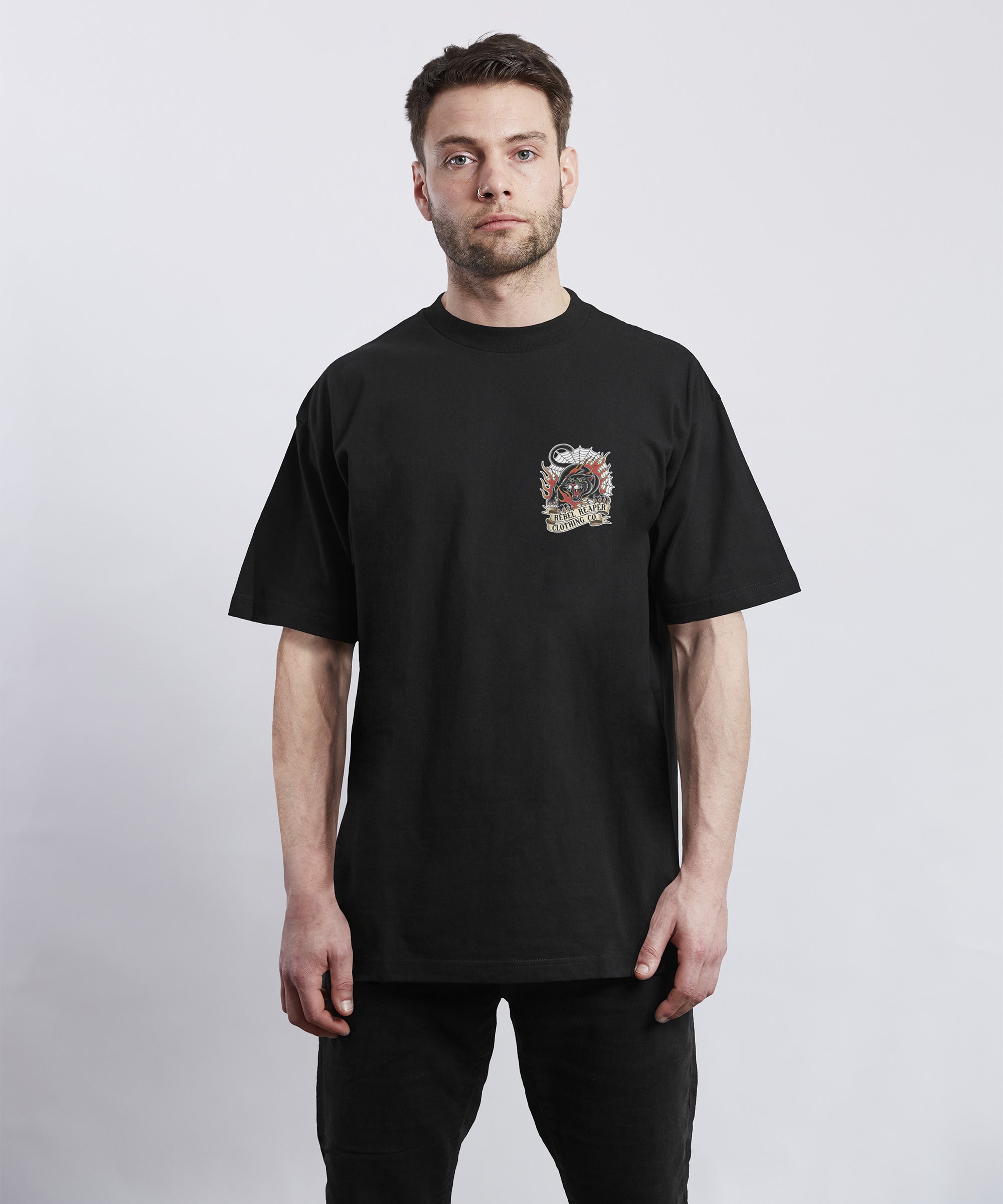 Man wearing a black t-shirt with a graphic design on a white background