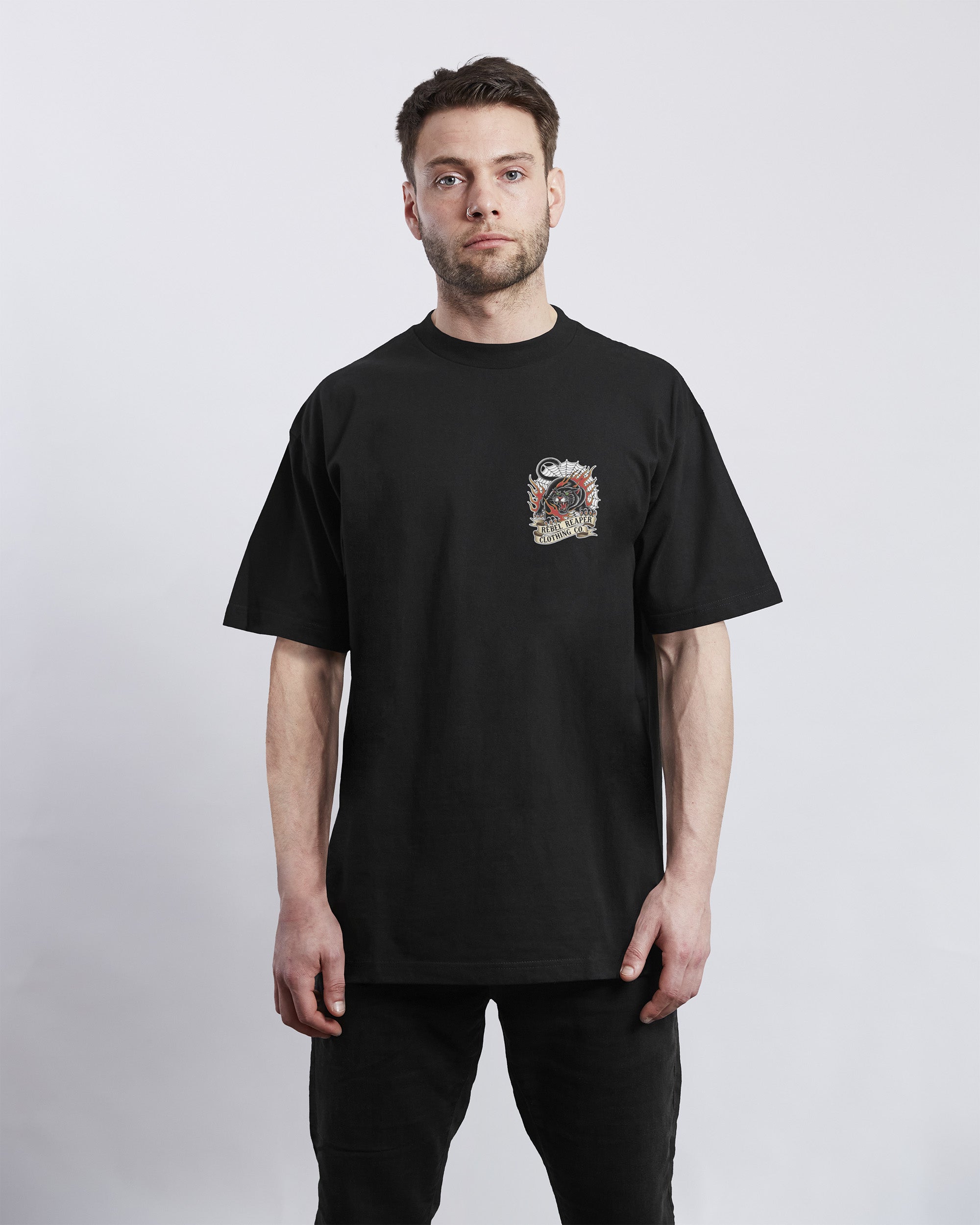 Man wearing a black t-shirt with a graphic design on a white background