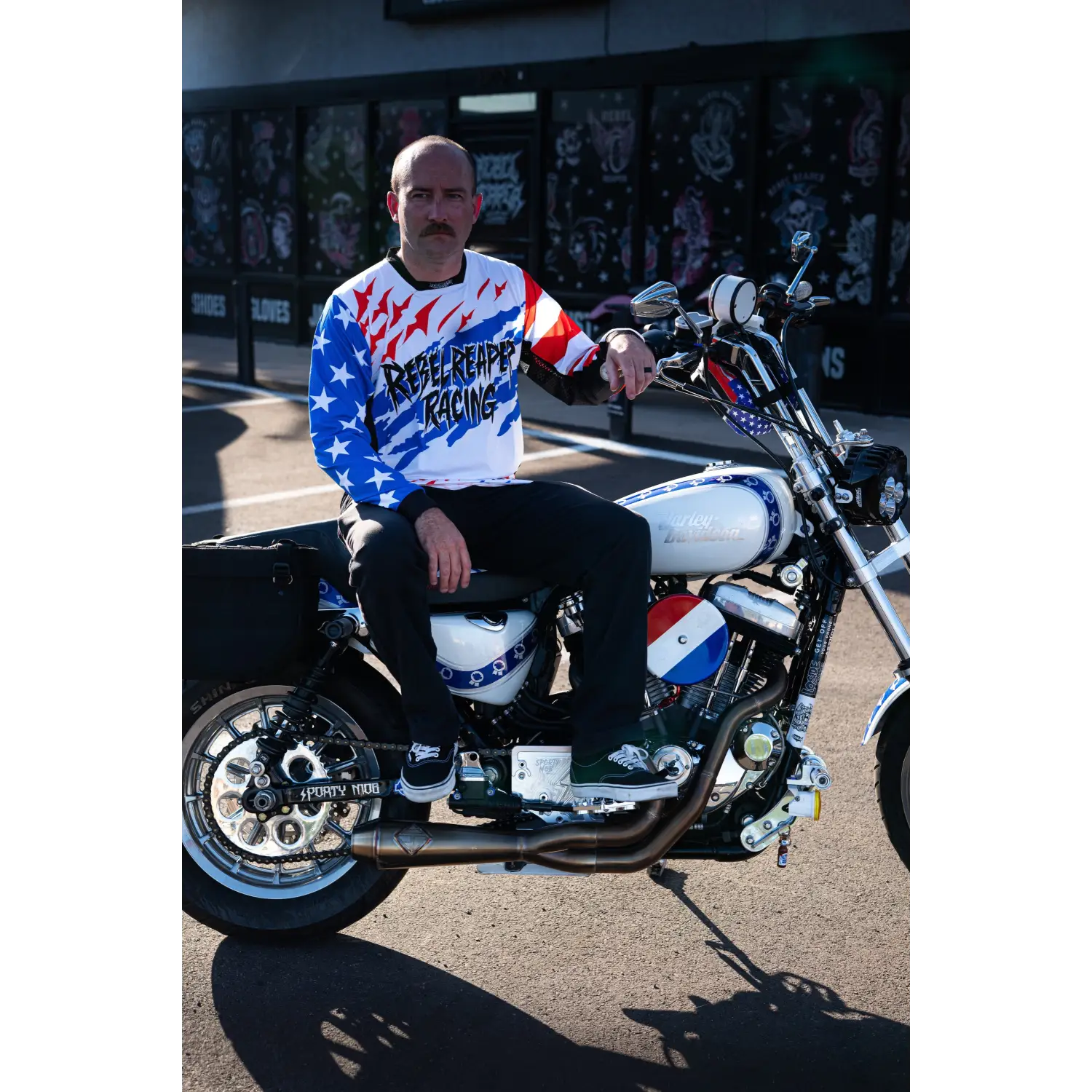 Patriotic motorcycle with rider wearing Rebel Reaper Racing Never Lose Crew Jersey fly high or blow past