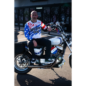 Patriotic motorcycle with rider wearing Rebel Reaper Racing Never Lose Crew Jersey fly high or blow past