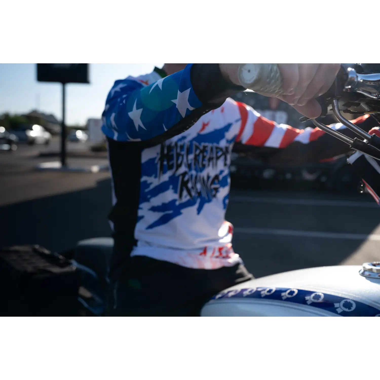 Patriotic motorcycle rider wearing Rebel Reaper Racing fly high Never Lose Crew jersey