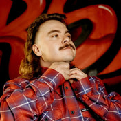 Man with mullet wearing Anaglyph Mens Flannel Shirt in premium fabric, rebel reaper style