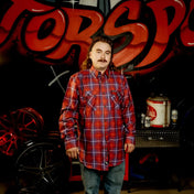 Man with a mullet wearing a mens flannel shirt in rebel reaper premium fabric