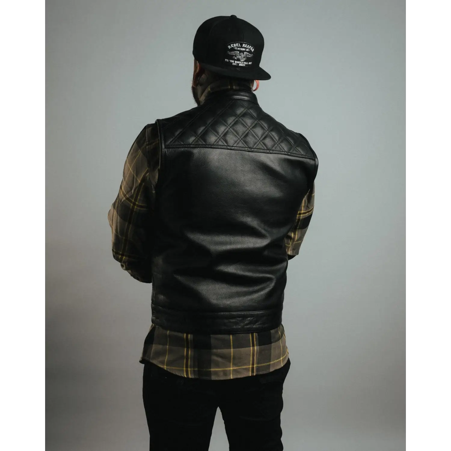 Black leather vest with quilted shoulders, YKK zippers, cowhide leather carry pockets