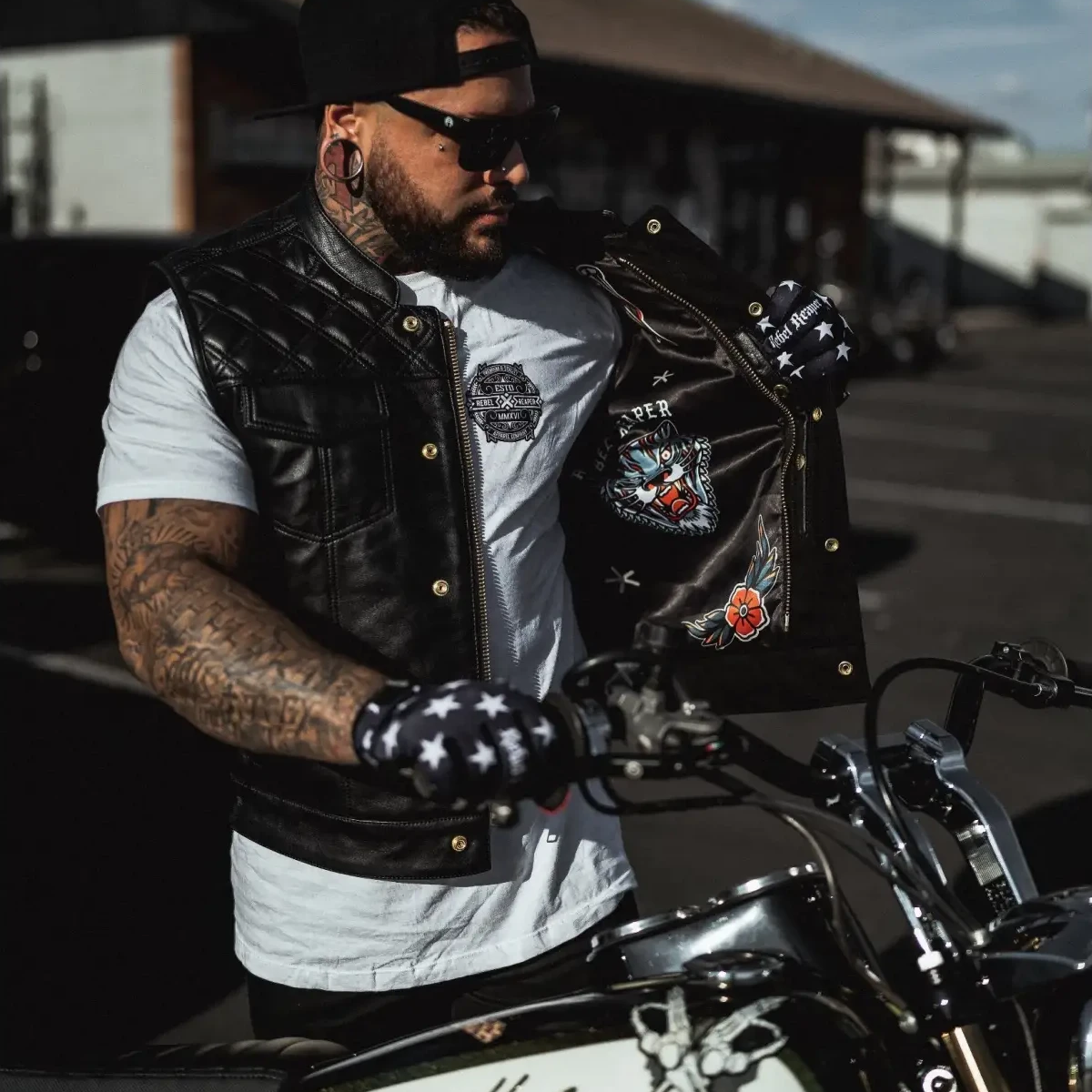 Biker with Harley-Davidson motorcycle wearing Back In Black Leather Vest featuring double diamond vest and YKK zippers