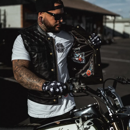 Biker with Harley-Davidson motorcycle wearing Back In Black Leather Vest featuring double diamond vest and YKK zippers