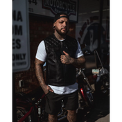 Tattooed man in black leather vest with concealed carry pockets and double diamond stitching