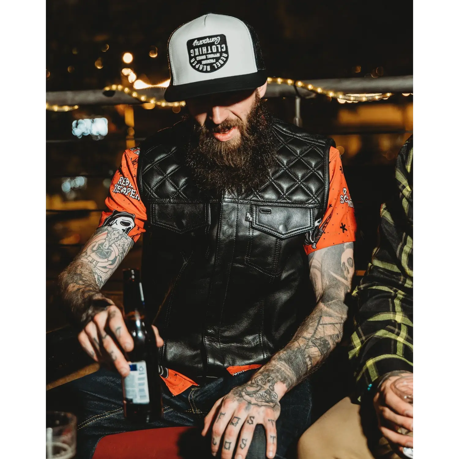 Bearded man in Collarless Back In Black Leather Vest with concealed carry pockets and double diamond stitching