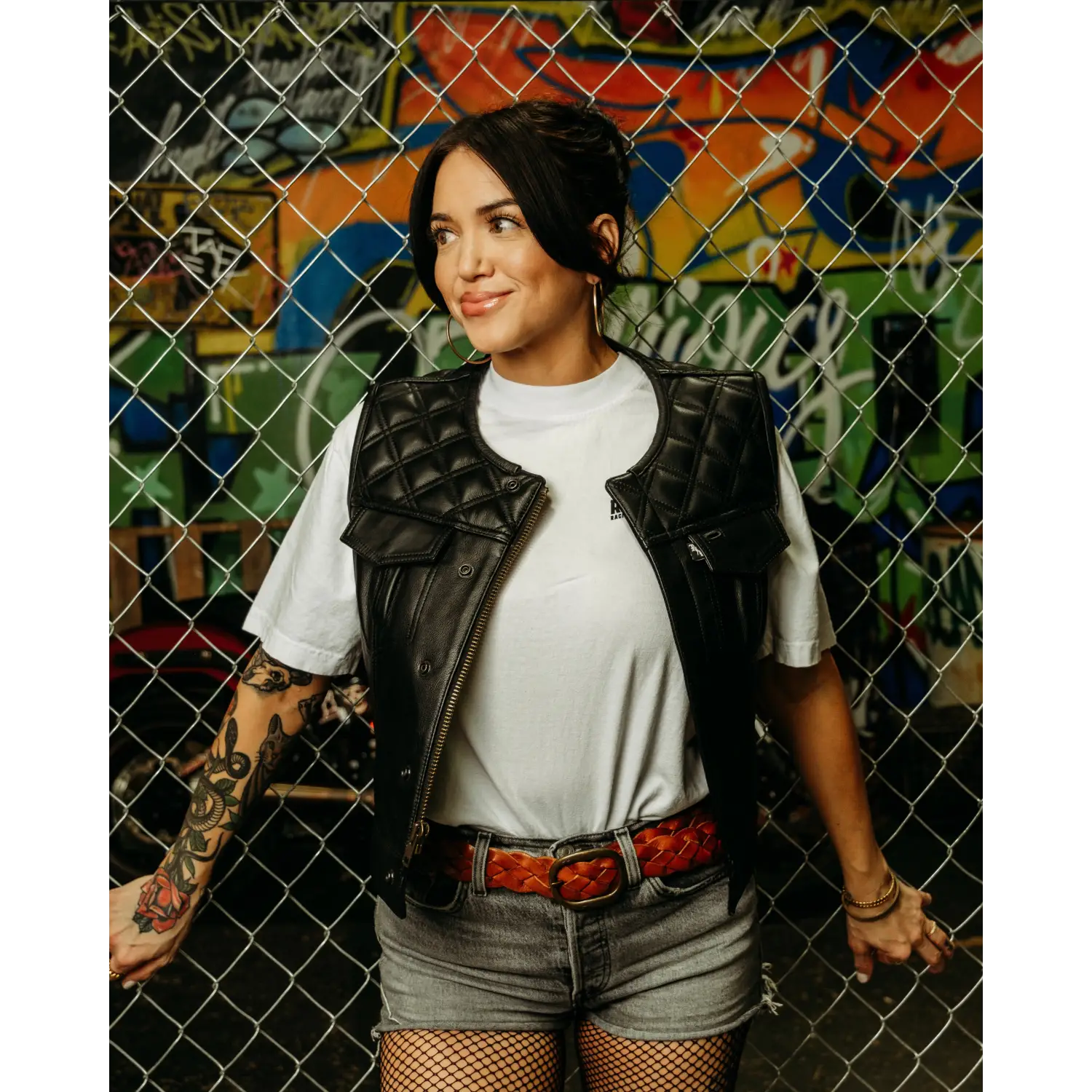 Woman in Back In Black Women’s Leather Vest with conceal carry pockets and cowhide leather