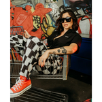 Woman in checkered pants and red sneakers wearing Black Bamboo Button Up Shirt with wrinkle-resistant fabric