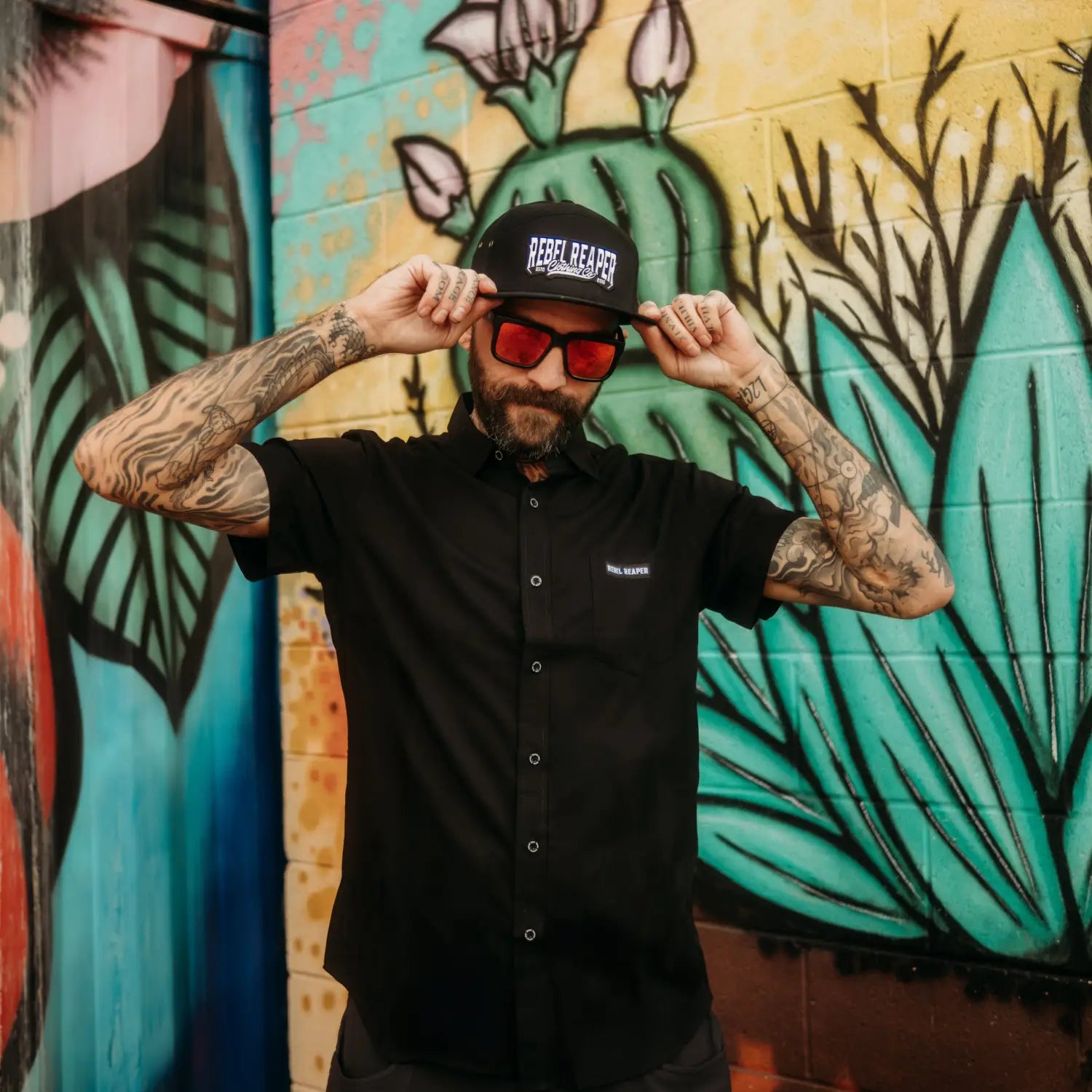 Man in black bamboo short sleeve button-up shirt with hidden collar buttons