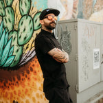 Man with tattoos in sunglasses and hat wearing Black Bamboo Button Up Shirt S/S with hidden collar buttons