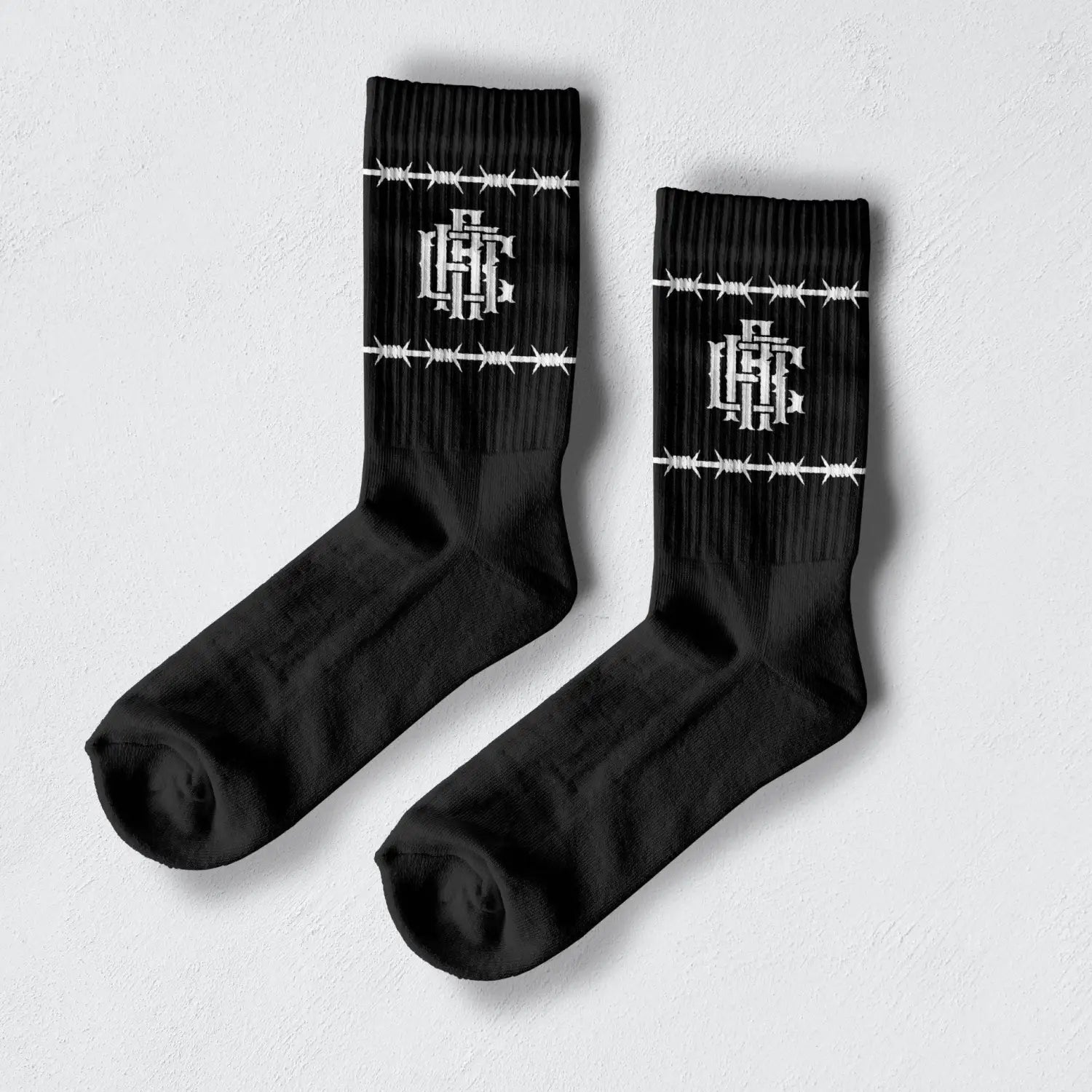 Black Barb Wire Crew Socks with white barbed wire design and premium comfort combed cotton