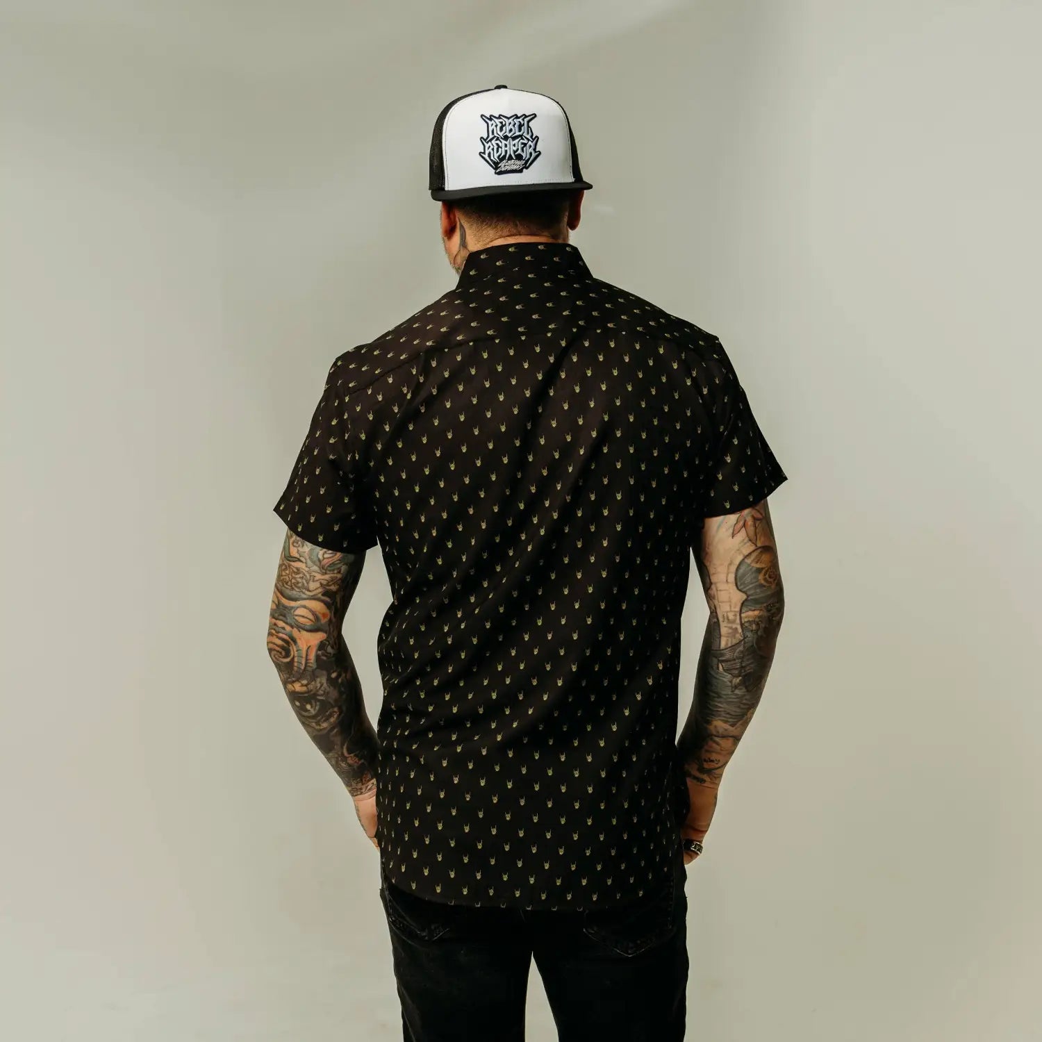 Black patterned short-sleeve shirt with yellow metal hands and hidden collar buttons