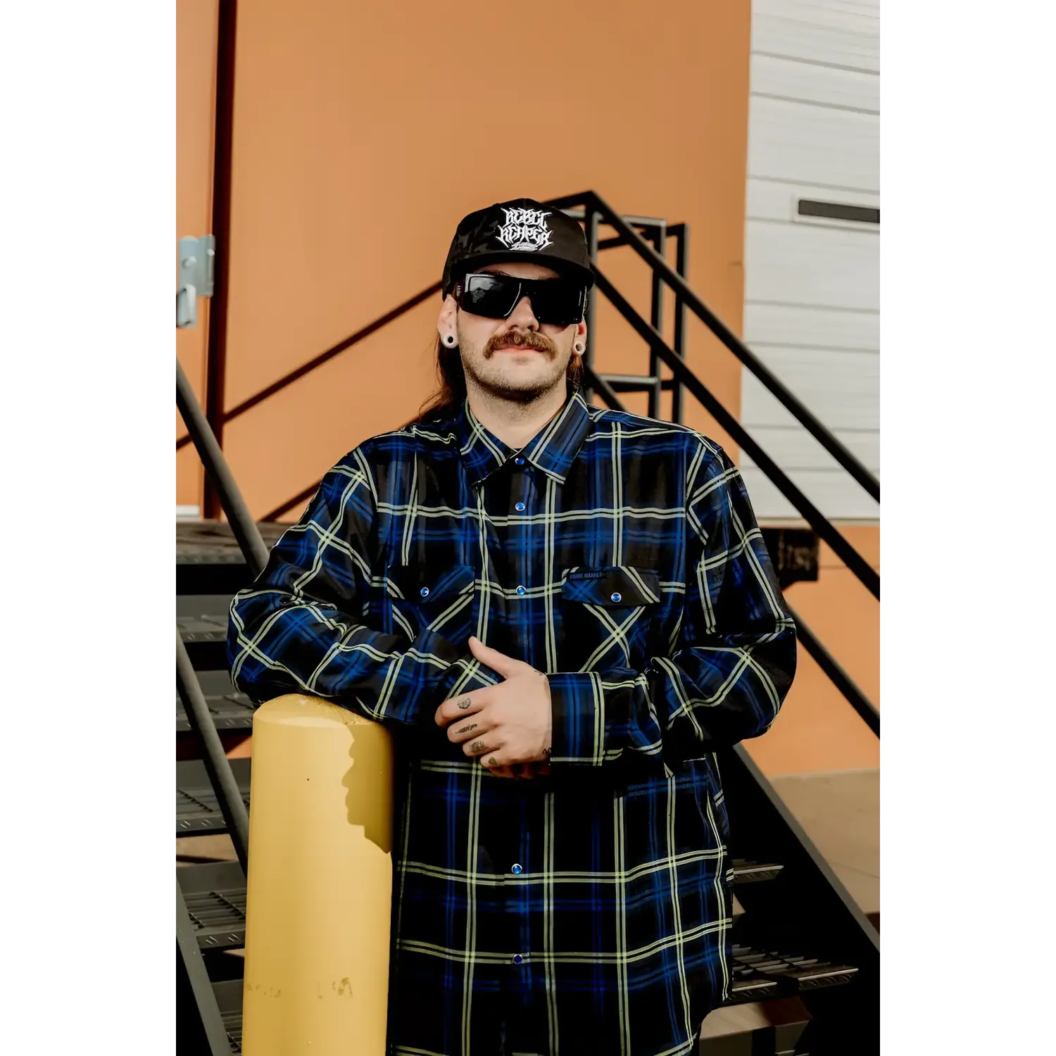 Man in plaid shirt from Rebel Reaper exclusive design with pleat fit in Block Mens Flannel