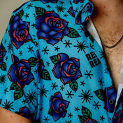 Blue Flash of Roses blue short sleeve button-up shirt with bold purple roses pattern