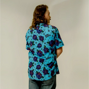 Blue floral short sleeve button-up shirt featuring bold purple roses pattern
