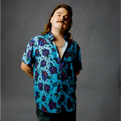 Man in blue short sleeve button-up shirt with bold purple roses from Blue Flash of Roses