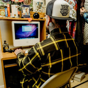 Man using iMac wearing Burgh Flannel Shirt Rebel Reaper exclusive design