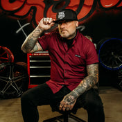 Tattooed man in a maroon Burgundy Bamboo Button Up Shirt S/S with hidden collar buttons