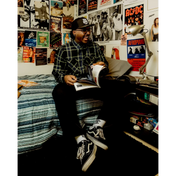 Man reading magazine wearing Burton Men’s Flannel with hidden collar buttons and chest pocket slits