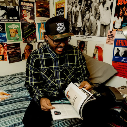 Man reading a magazine wearing Burton Mens Flannel with hidden collar buttons and chest pocket slits