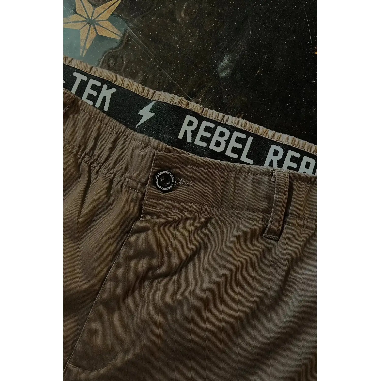 Brown chino pants with REBEL waistband showcasing Flex-Tek stretch for a rebel reaper style