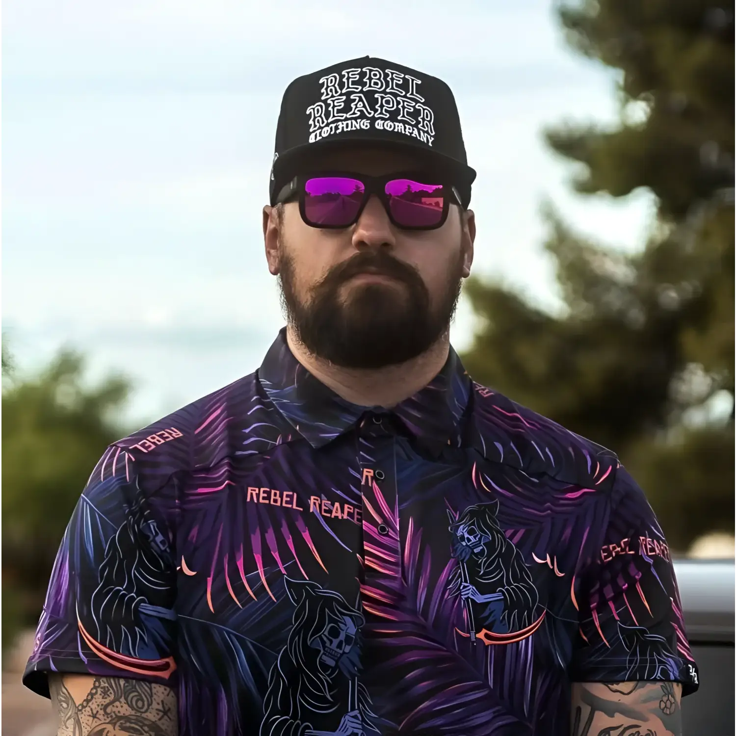 Man wearing Rebel Reaper hat and shirt from Dillinger Squared UV400 sunglass collection with interchangeable arms