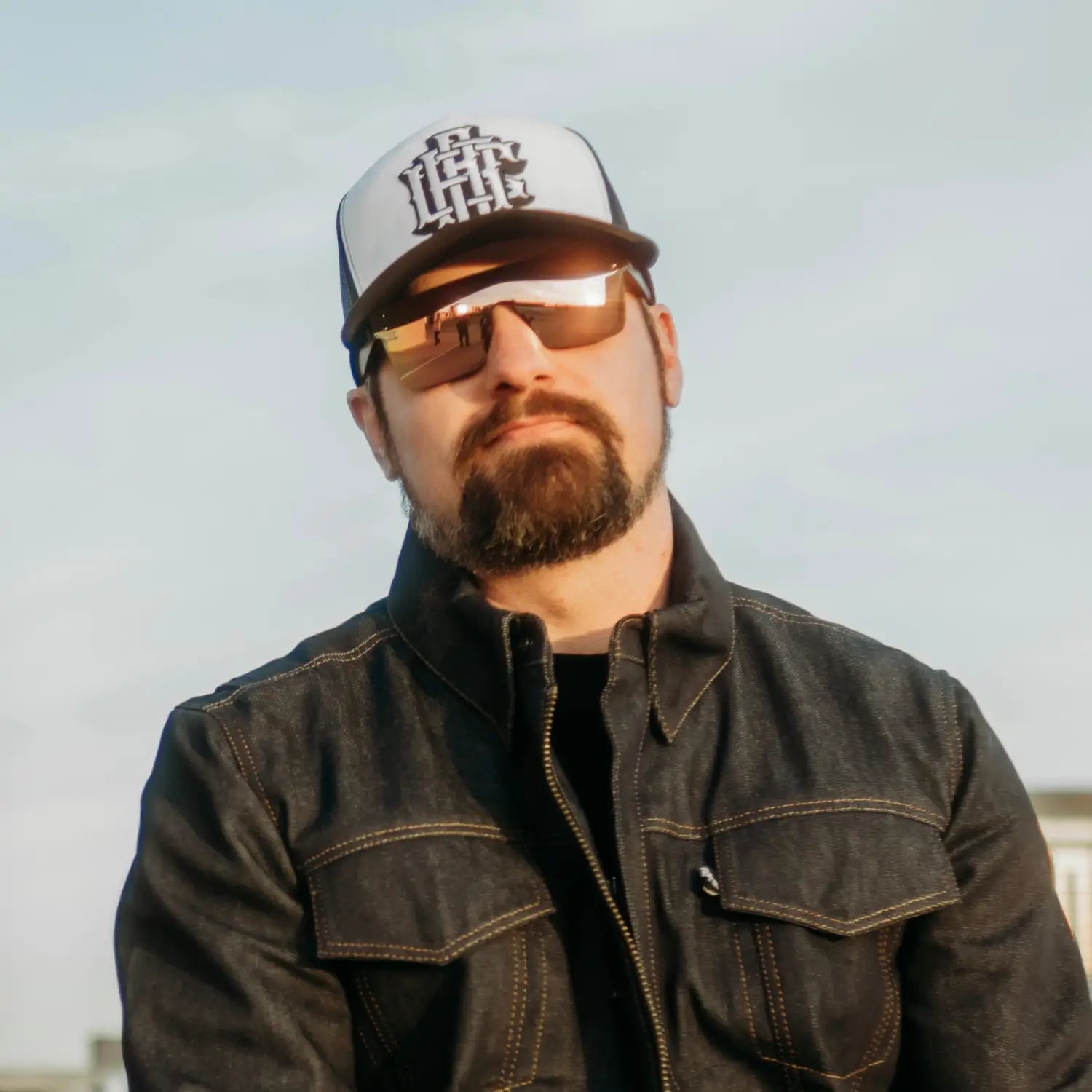 Man wearing rebel reaper flair polarized sunglass with tattoo flash design and trucker hat