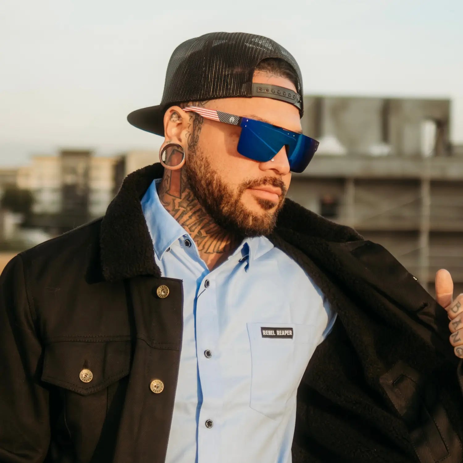 Tattooed man wearing Flair Polarized Sunglasses from Rebel Reaper Tattoo Flash collection