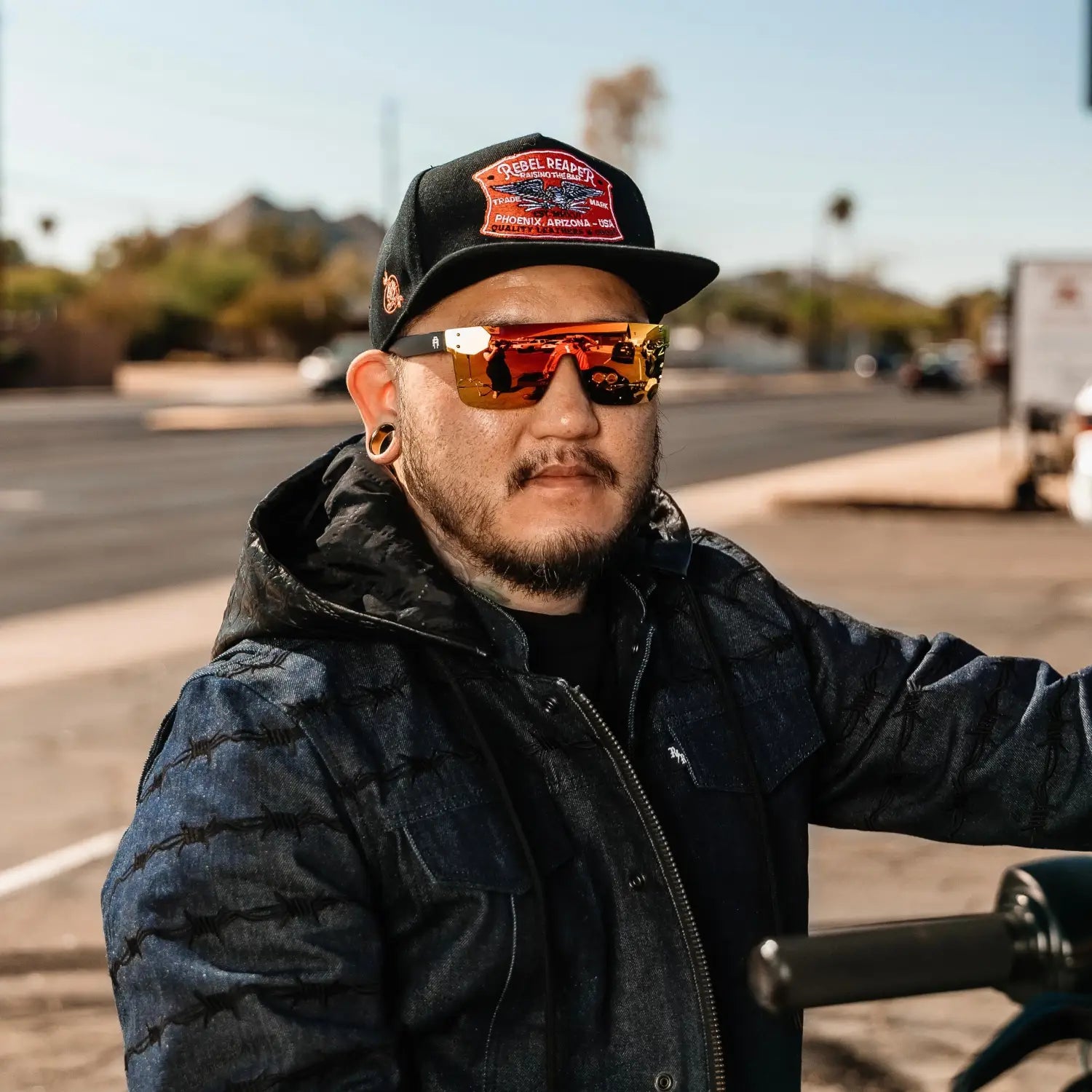 Man wearing rebel reaper flair polarized sunglasses with tattoo flash design