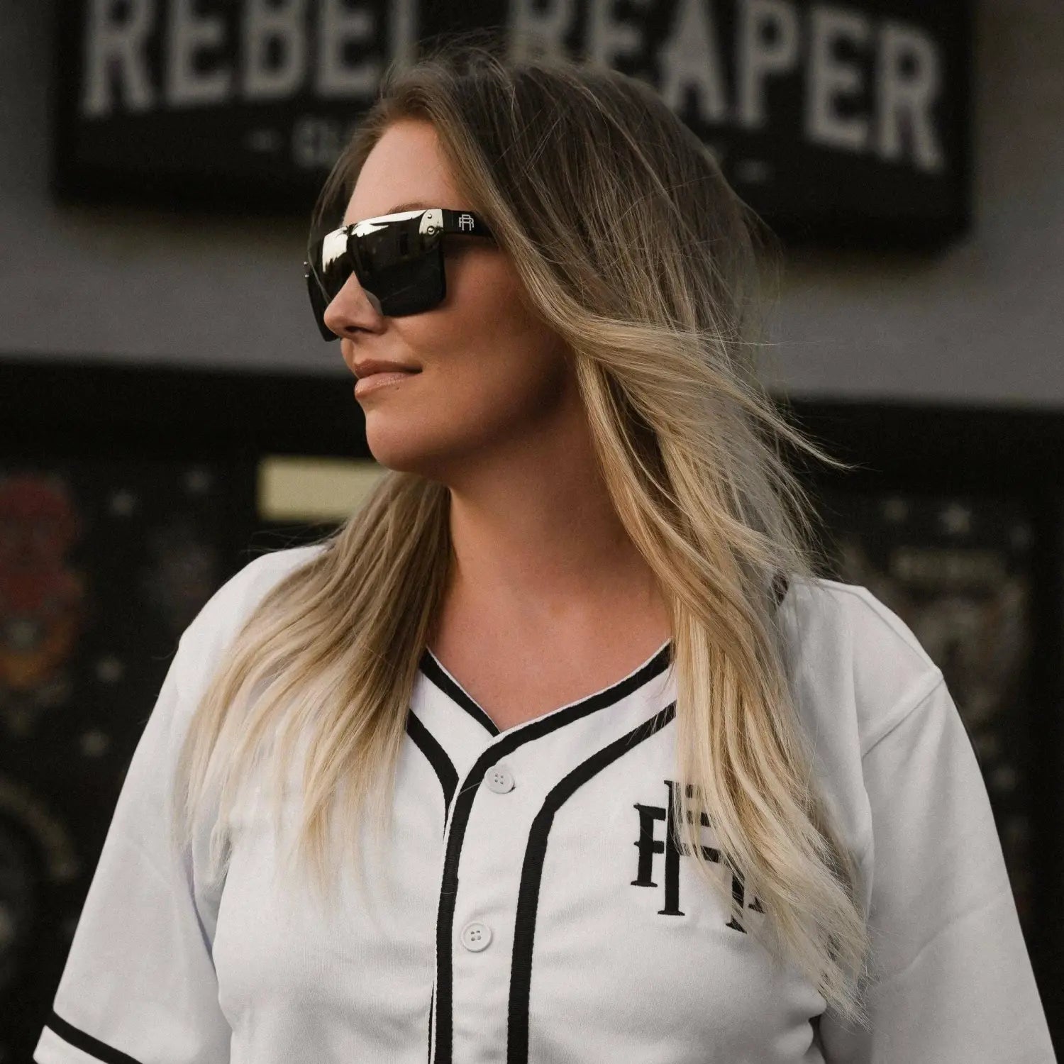 Woman wearing Flair Polarized Sunglasses from Rebel Reaper collection with tattoo flash style